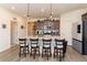 Stylish kitchen featuring an island with bar stool seating and stainless steel appliances at 2149 Indian Balsam Dr, Monument, CO 80132