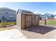 A backyard shed surrounded by gravel and featuring wood siding with a single window at 2149 Indian Balsam Dr, Monument, CO 80132