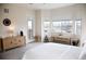Airy bedroom with mountain views from three windows, a walkout balcony, and rustic, light wood furnishings at 3910 Mighty Oaks St, Castle Rock, CO 80104