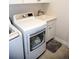 Convenient laundry area with modern white appliances and utility sink at 3910 Mighty Oaks St, Castle Rock, CO 80104