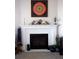 Living room fireplace with white mantel and unique decor creates a cozy, inviting atmosphere at 3910 Mighty Oaks St, Castle Rock, CO 80104