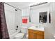 Bathroom featuring a shower and bathtub with tiled surround and a wooden vanity with large mirror at 2277 S Buckley Rd # 102, Aurora, CO 80013