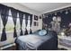 Gothic style bedroom with a black bedspread, decor, and window dressings at 2277 S Buckley Rd # 102, Aurora, CO 80013