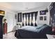 Stylish bedroom with dark walls, window, and minimalist decor and wood flooring at 2277 S Buckley Rd # 102, Aurora, CO 80013