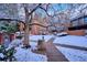Snowy common area features mature trees and a walking path for resident enjoyment at 2277 S Buckley Rd # 102, Aurora, CO 80013