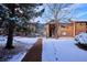 Exterior view in winter with snow covered landscaping and wood and brick facade at 2277 S Buckley Rd # 102, Aurora, CO 80013