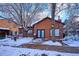 Exterior view of the community clubhouse with snow covered trees and landscaping at 2277 S Buckley Rd # 102, Aurora, CO 80013