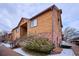 Well-maintained two-story condo with wood siding, brick accents, and community parking at 2277 S Buckley Rd # 102, Aurora, CO 80013