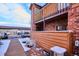 Exterior view of the home with wood siding and covered parking in winter conditions at 2277 S Buckley Rd # 102, Aurora, CO 80013