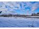 A snow-covered landscape view of trees in the distance under a beautiful sky at 2277 S Buckley Rd # 102, Aurora, CO 80013