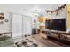 Inviting living room with wood floors, large window, and open layout to the kitchen at 2277 S Buckley Rd # 102, Aurora, CO 80013