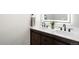 Bathroom with a modern vanity featuring double sinks, sleek black faucets, and a stylish wood cabinet at 14353 E 1St Dr # 301, Aurora, CO 80011