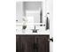 Bathroom vanity with a white countertop, dark wood cabinets, matte black hardware, and a lighted mirror at 14353 E 1St Dr # 301, Aurora, CO 80011