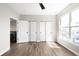 Spacious bedroom featuring a modern ceiling fan, wood floors, and ample natural light from a large window at 14353 E 1St Dr # 301, Aurora, CO 80011