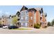 Attractive exterior of a multi-story building with brick and gray siding, balconies, and well-maintained landscaping at 14353 E 1St Dr # 301, Aurora, CO 80011