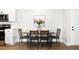 Dining area featuring contemporary table set with wooden chairs, art piece on wall, and white cabinets at 14353 E 1St Dr # 301, Aurora, CO 80011