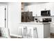 Modern kitchen featuring stainless steel appliances, white cabinets, and a center island with counter seating at 14353 E 1St Dr # 301, Aurora, CO 80011