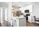 Bright kitchen featuring stainless steel appliances, white cabinets, and a center island with counter seating at 14353 E 1St Dr # 301, Aurora, CO 80011