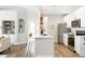 Bright kitchen featuring stainless steel appliances, white cabinets, and a center island with counter seating at 14353 E 1St Dr # 301, Aurora, CO 80011
