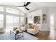 Bright living room featuring vaulted ceilings, a tiled fireplace, and hardwood floors at 14353 E 1St Dr # 301, Aurora, CO 80011