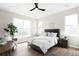A bright and airy main bedroom featuring a large window and a modern ceiling fan at 14353 E 1St Dr # 301, Aurora, CO 80011