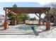 Outdoor pool area featuring a wooden pergola, a safety fence, and a relaxing seating area at 14353 E 1St Dr # 301, Aurora, CO 80011