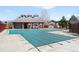 Community pool with a partially covered patio area and a protective safety cover at 14353 E 1St Dr # 301, Aurora, CO 80011
