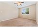 Bright bedroom with plush carpet, a ceiling fan, and a window with views of the surroundings at 9637 E 5Th Ave # 101, Denver, CO 80230