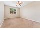 Spacious bedroom with neutral carpet, ceiling fan, and natural light from the window at 9637 E 5Th Ave # 101, Denver, CO 80230