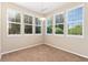 Dining area featuring large windows and neutral carpeting at 9637 E 5Th Ave # 101, Denver, CO 80230