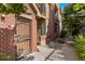 Charming brick townhome featuring a secure front door and a well-maintained walkway at 9637 E 5Th Ave # 101, Denver, CO 80230