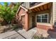 Exterior patio area with brick, landscaping, security doors and railings at 9637 E 5Th Ave # 101, Denver, CO 80230