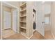 Hallway with storage shelves and in-unit washer and dryer at 9637 E 5Th Ave # 101, Denver, CO 80230