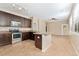 Kitchen featuring tiled floors, stainless appliances, and an eat-in peninsula at 9637 E 5Th Ave # 101, Denver, CO 80230