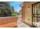 Patio area with a brick surround, fence, and an entrance door at 9637 E 5Th Ave # 101, Denver, CO 80230