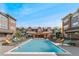 Community pool with lounge chairs and umbrellas, surrounded by attractive residences at 9637 E 5Th Ave # 101, Denver, CO 80230
