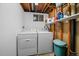 Basement laundry area equipped with a washer, dryer, and shelving for storage at 31 Circle Dr, Castle Rock, CO 80104