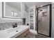 Modern bathroom features a glass shower, mosaic backsplash, and a sleek vanity at 31 Circle Dr, Castle Rock, CO 80104