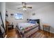 Cozy bedroom featuring hardwood floors, a colorful quilt, and a ceiling fan at 31 Circle Dr, Castle Rock, CO 80104