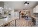 Bright eat-in kitchen with white appliances, countertop seating and an open view to the dining room at 31 Circle Dr, Castle Rock, CO 80104