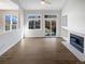 Bright living room with sliding glass door to backyard patio, ceiling fan, and fireplace at 5302 S Danube Ct, Centennial, CO 80015