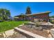 A beautifully landscaped backyard with a covered patio and brick accents at 10684 Downing St, Northglenn, CO 80233