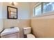 This half-bathroom is well-lit and features ceramic tiled walls at 10684 Downing St, Northglenn, CO 80233
