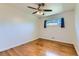 This bright bedroom has hardwood floors, a window, and a ceiling fan at 10684 Downing St, Northglenn, CO 80233