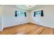 This light-filled bedroom boasts hardwood floors and two bright windows at 10684 Downing St, Northglenn, CO 80233