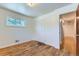 Bedroom with closet, hardwood floors, and large window at 10684 Downing St, Northglenn, CO 80233