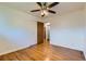 Bright bedroom features hardwood floors, a ceiling fan, and an attached closet at 10684 Downing St, Northglenn, CO 80233