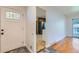 Open entryway featuring hardwood floors and a view into the kitchen and living area at 10684 Downing St, Northglenn, CO 80233