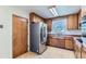 Traditional kitchen features wood cabinetry and updated stainless-steel appliances at 10684 Downing St, Northglenn, CO 80233