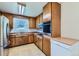 Traditional kitchen features wood cabinetry and updated stainless-steel appliances at 10684 Downing St, Northglenn, CO 80233